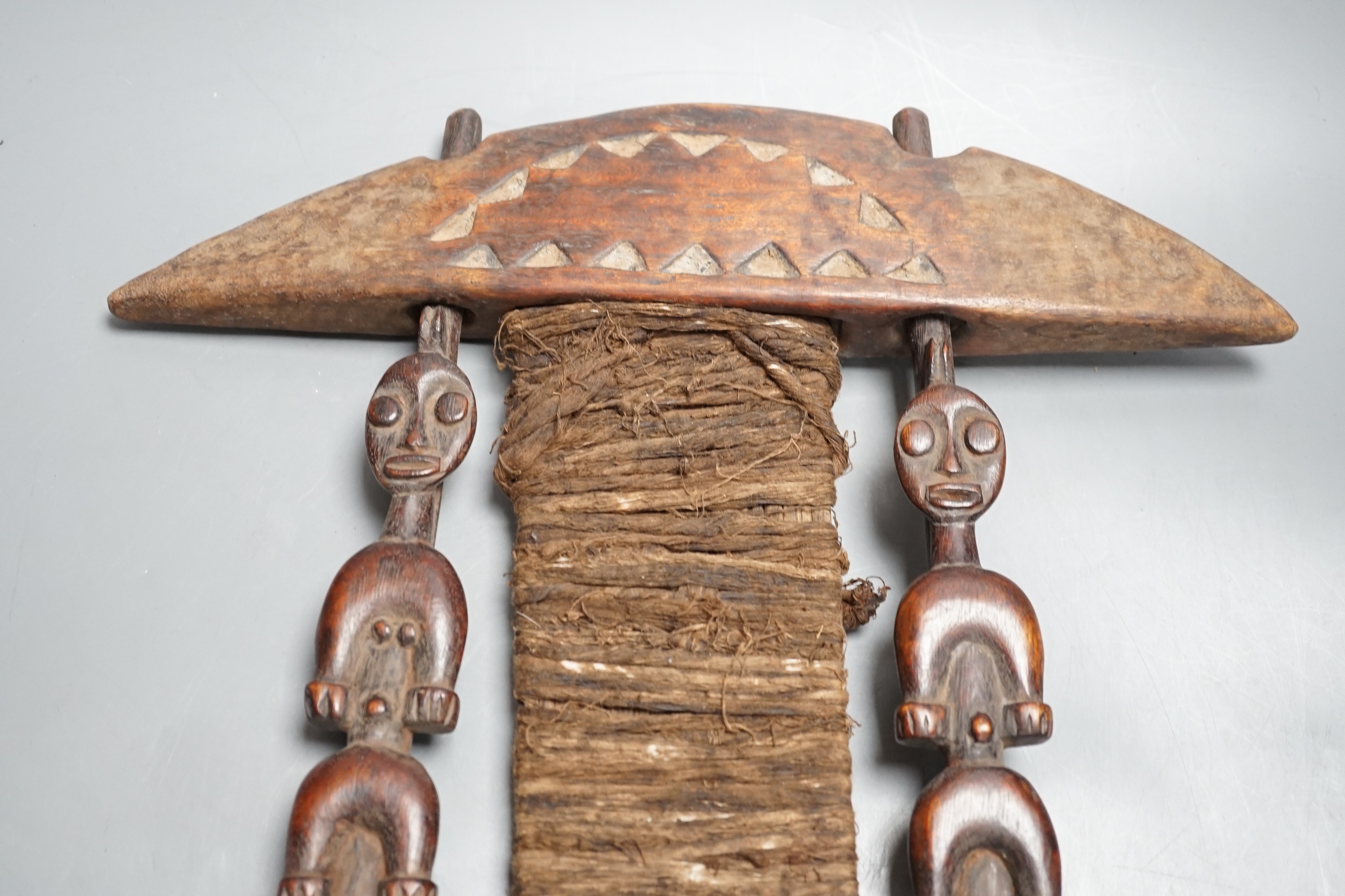 African carved wood instrument, chip carved beech box, a GWR brass wall lamp and a pair of oil portraits of H Belloc and HG Wells